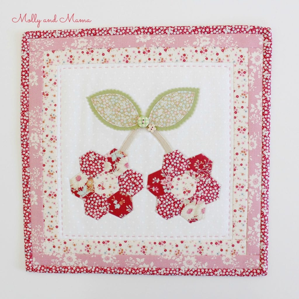 A cherry hexie mini quilt by Molly and Mama